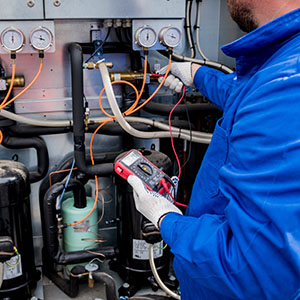 Technician utilizing electrical skills in HVAC repair